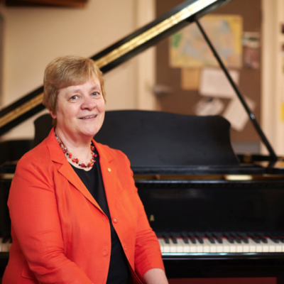 Elizabeth Koch next to piano