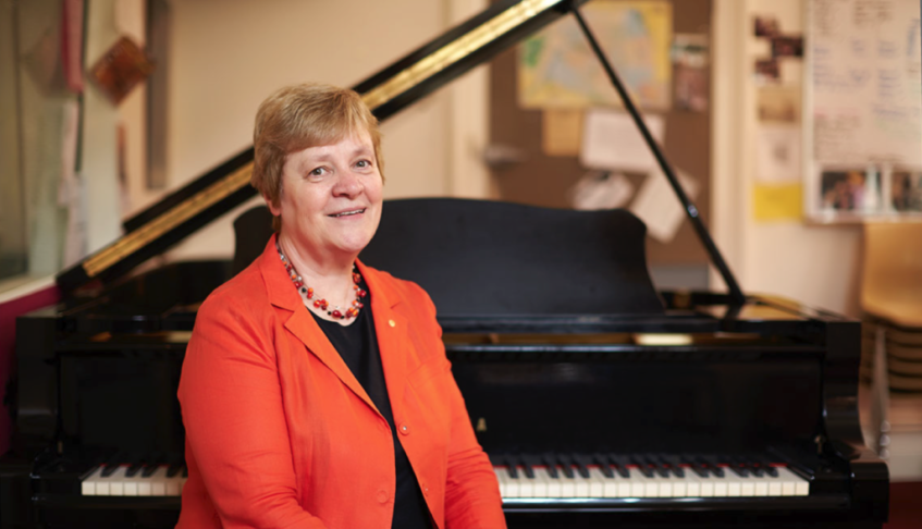 Elizabeth Koch next to piano